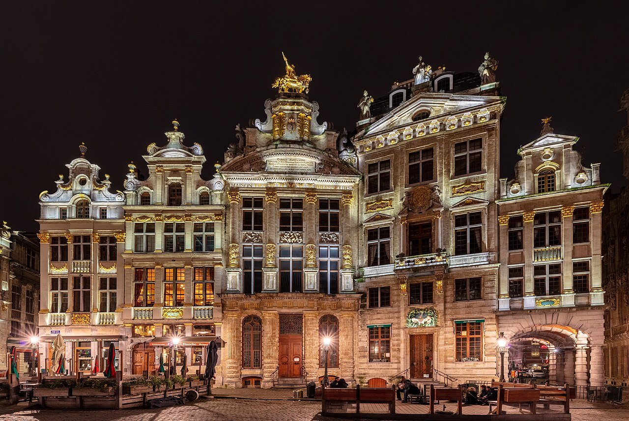 Ornate gilded guildhouses lining the Grand-Place, seen across the cobbled square.